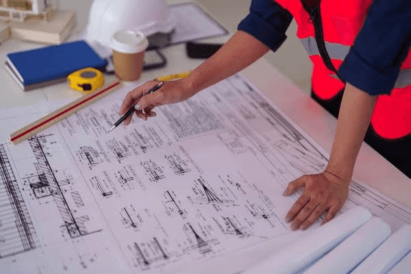 Engineering team reviewing high-voltage schematics